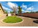 Well-maintained backyard featuring a manicured lawn, gravel landscaping, and a metal gazebo frame for a serene outdoor retreat at 3233 N 137Th Dr, Avondale, AZ 85392