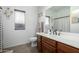 Cozy bathroom featuring a wood vanity, large mirror, and decorative shower curtain, providing a clean and functional space at 3233 N 137Th Dr, Avondale, AZ 85392