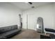 Bedroom featuring neutral carpet, a daybed, closet and full-length mirror, ideal for versatile use and space optimization at 3233 N 137Th Dr, Avondale, AZ 85392