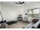 Bedroom with a ceiling fan, daybed, vanity, and exercise equipment, offering a versatile space for relaxation and fitness at 3233 N 137Th Dr, Avondale, AZ 85392