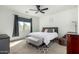 Cozy bedroom featuring a ceiling fan, a window with curtains, and comfortable furnishings at 3233 N 137Th Dr, Avondale, AZ 85392