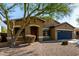 Charming single-story home featuring a well-maintained landscape and a two-car garage at 3233 N 137Th Dr, Avondale, AZ 85392