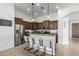 Elegant kitchen featuring stainless steel appliances, a breakfast bar, and modern lighting at 3233 N 137Th Dr, Avondale, AZ 85392