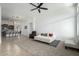 Spacious living room features a neutral color palette, ceiling fan, and comfortable seating area at 3233 N 137Th Dr, Avondale, AZ 85392