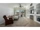 Inviting living room with a fireplace, sliding glass doors, and a ceiling fan for optimal comfort at 3233 N 137Th Dr, Avondale, AZ 85392