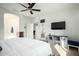 Bright main bedroom featuring a ceiling fan, TV, and access to an ensuite bathroom and private patio at 3233 N 137Th Dr, Avondale, AZ 85392