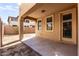 An empty back patio outside with columns, shade, and a door leading into the house at 3235 E Virgil Dr, Gilbert, AZ 85298