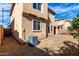 View of the home's rear exterior featuring a small brick patio and side yard at 3235 E Virgil Dr, Gilbert, AZ 85298