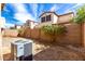 Backyard with brick perimeter wall, mature landscaping, and air conditioning unit at 3235 E Virgil Dr, Gilbert, AZ 85298