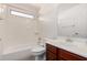 A well-lit bathroom features a vanity with cherry cabinets and a shower-tub combo at 3235 E Virgil Dr, Gilbert, AZ 85298