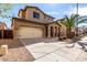 Inviting two-story home featuring a spacious driveway and well-manicured desert landscaping at 3235 E Virgil Dr, Gilbert, AZ 85298