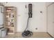 Garage featuring a central vacuum, shelving, and water heater at 3235 E Virgil Dr, Gilbert, AZ 85298