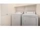 A well-lit laundry room featuring a side-by-side washer and dryer at 3235 E Virgil Dr, Gilbert, AZ 85298