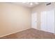 Bedroom with plush carpeting, ceiling fan, closet, and a door to another room at 3522 E Edna Ave, Phoenix, AZ 85032