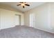 Large bedroom with carpet, a ceiling fan, and two doors at 3522 E Edna Ave, Phoenix, AZ 85032