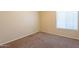 This bedroom features neutral walls and carpet, with a window dressed with blinds at 3522 E Edna Ave, Phoenix, AZ 85032