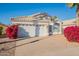 Charming single-story home featuring a two-car garage, tile roof, and desert landscaping with vibrant bougainvillea at 3522 E Edna Ave, Phoenix, AZ 85032