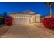 Charming single-story home with a well-maintained front yard and two-car garage at dusk at 3522 E Edna Ave, Phoenix, AZ 85032