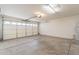 Spacious garage with an automatic door opener, concrete flooring, and ample lighting at 3522 E Edna Ave, Phoenix, AZ 85032