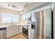 Kitchen featuring stainless steel appliances, tile backsplash, and white cabinets at 3522 E Edna Ave, Phoenix, AZ 85032