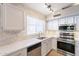 Kitchen featuring a stainless steel dishwasher, sink, oven, and white countertops at 3522 E Edna Ave, Phoenix, AZ 85032