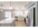 Renovated kitchen with white cabinets, quartz countertops, and stainless steel refrigerator at 3522 E Edna Ave, Phoenix, AZ 85032