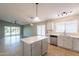 Open kitchen featuring stainless appliances, a kitchen island and access to the living room at 3522 E Edna Ave, Phoenix, AZ 85032