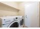 Laundry area featuring a front-load washer and dryer with a wire shelf above at 3522 E Edna Ave, Phoenix, AZ 85032