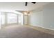 Bright and airy living room featuring neutral carpet, and large window at 3522 E Edna Ave, Phoenix, AZ 85032