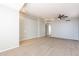 Neutral living room with light gray walls, carpet and tile flooring, and a ceiling fan at 3522 E Edna Ave, Phoenix, AZ 85032