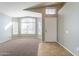 Bright and airy living room featuring neutral carpet, and large window at 3522 E Edna Ave, Phoenix, AZ 85032