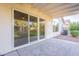 Covered patio with outdoor rug and sliding glass doors leading to a landscaped backyard at 3522 E Edna Ave, Phoenix, AZ 85032