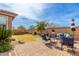 Landscaped backyard with seating area, mature trees, and stone pavers at 35306 N 31St Dr, Phoenix, AZ 85086