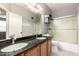 Double sink bathroom with granite countertops and a shower-tub combo at 35306 N 31St Dr, Phoenix, AZ 85086