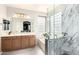 Stylish bathroom featuring double sinks, soaking tub, and tiled shower at 35306 N 31St Dr, Phoenix, AZ 85086