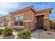 Single-story home with stone accents and a well-maintained desert-landscaped front yard and walkway at 35306 N 31St Dr, Phoenix, AZ 85086