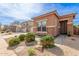 Single-story home with stone accents and a well-maintained desert-landscaped front yard and walkway at 35306 N 31St Dr, Phoenix, AZ 85086