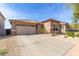 Single-story home with a desert landscape, garage and tile roof. A well-maintained front yard at 35306 N 31St Dr, Phoenix, AZ 85086