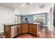 Open concept kitchen with dark countertops, stainless steel dishwasher and hardwood floors at 35306 N 31St Dr, Phoenix, AZ 85086