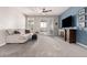 Living room features a large gray sofa, blue accent wall, neutral carpet, and natural light from sliding doors at 35306 N 31St Dr, Phoenix, AZ 85086