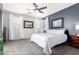 Serene main bedroom with a bright white comforter, ceiling fan, and natural light at 35306 N 31St Dr, Phoenix, AZ 85086