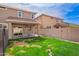 Backyard featuring green grass, exterior elevation with covered patio and sliding glass doors with seating at 3532 E Alfalfa Dr, Gilbert, AZ 85298