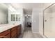 The bathroom features a dual sink vanity, a walk-in shower, and a bedroom view at 3532 E Alfalfa Dr, Gilbert, AZ 85298