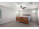 Cozy bedroom with natural light and neutral carpeted floors, complemented by a ceiling fan at 3532 E Alfalfa Dr, Gilbert, AZ 85298