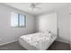 Cozy bedroom with carpet flooring, white ceiling fan, and large window with blinds at 3532 E Alfalfa Dr, Gilbert, AZ 85298