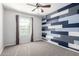 Bedroom with carpet flooring, ceiling fan and unique blue-gray paneled accent wall at 3532 E Alfalfa Dr, Gilbert, AZ 85298