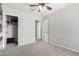 Cozy bedroom featuring neutral tones, carpet floors, closet, and ceiling fan for comfortable living at 3532 E Alfalfa Dr, Gilbert, AZ 85298