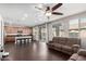 Open-concept living room and kitchen with a ceiling fan, sliding glass doors, and dark floors at 3532 E Alfalfa Dr, Gilbert, AZ 85298