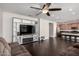 Open-concept living space with hardwood floors, modern lighting, and seamless flow into kitchen at 3532 E Alfalfa Dr, Gilbert, AZ 85298