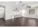 Spacious living room featuring dark floors, a ceiling fan, and a view of the front yard at 3532 E Alfalfa Dr, Gilbert, AZ 85298